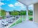 Balcony with white railing overlooking a well-maintained lawn and parking area at 290 Woodlands Way Nw # 10, Calabash, SC 28467