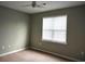 This bedroom has neutral walls and carpet, a ceiling fan, and plenty of natural light at 290 Woodlands Way Nw # 10, Calabash, SC 28467