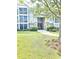 Attractive condo building exterior with brick accents, sidewalks, and professionally maintained landscaping at 290 Woodlands Way Nw # 10, Calabash, SC 28467