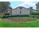 Crow Creek Golf Club entrance sign surrounded by colorful flowers and lush greenery at 290 Woodlands Way Nw # 10, Calabash, SC 28467