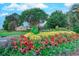 Landscaped entrance to Crow Creek Golf Club with colorful flowers and trees at 290 Woodlands Way Nw # 10, Calabash, SC 28467
