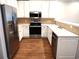 Modern kitchen with stainless steel appliances, granite countertops, and white cabinets at 290 Woodlands Way Nw # 10, Calabash, SC 28467
