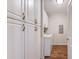 Well-lit laundry room with ample storage cabinets and modern appliances at 290 Woodlands Way Nw # 10, Calabash, SC 28467