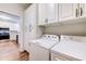 Functional laundry area with side by side washer and dryer setup and lots of cabinet storage at 290 Woodlands Way Nw # 10, Calabash, SC 28467