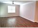 Bright and spacious living room featuring wood floors, a ceiling fan and window providing natural light at 290 Woodlands Way Nw # 10, Calabash, SC 28467