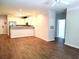 Open concept living area with modern flooring flowing into the updated kitchen with stainless appliances at 290 Woodlands Way Nw # 10, Calabash, SC 28467
