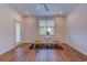 Spacious living room with wood floors, ceiling fan, and a decorative rug under a small table and chairs at 290 Woodlands Way Nw # 10, Calabash, SC 28467