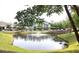 Scenic pond with a fountain, surrounded by lush greenery and community buildings at 290 Woodlands Way Nw # 10, Calabash, SC 28467
