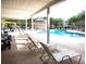 Relaxing poolside view with ample seating and shaded area overlooking the pool at 290 Woodlands Way Nw # 10, Calabash, SC 28467