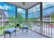 Enclosed porch featuring a view of the community and comfortable seating at 290 Woodlands Way Nw # 10, Calabash, SC 28467