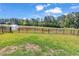 Spacious backyard featuring a well-maintained lawn, a wrought iron fence and a tranquil pond view at 305 Calhoun Falls Dr., Myrtle Beach, SC 29579