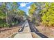 Wooden boardwalk leading through a lush green forest, perfect for nature walks at 305 Calhoun Falls Dr., Myrtle Beach, SC 29579
