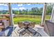 Inviting patio with outdoor seating, a fire pit, and views of the serene pond and trees at 305 Calhoun Falls Dr., Myrtle Beach, SC 29579
