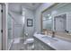 Bright bathroom featuring a gray vanity with a marble countertop, gray tile floors, and a walk-in shower at 307 Golden Bear Dr. # 3, Pawleys Island, SC 29585