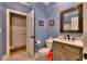 Cozy bathroom featuring a granite countertop, vanity cabinet, and a decorative framed mirror at 307 Golden Bear Dr. # 3, Pawleys Island, SC 29585