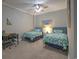 Bright bedroom featuring twin beds with matching floral bedding, complemented by a wooden desk and a tranquil, beach-themed decor at 307 Golden Bear Dr. # 3, Pawleys Island, SC 29585