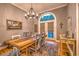 The dining room features wood floors, a rustic table, a chandelier, and a patio exit at 307 Golden Bear Dr. # 3, Pawleys Island, SC 29585