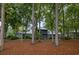 Charming home exterior with screened porch and views framed by mature trees and natural wooded surroundings at 307 Golden Bear Dr. # 3, Pawleys Island, SC 29585
