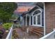 Lovely brick front porch with white railing, Adirondack chairs, and blue accent decor at 307 Golden Bear Dr. # 3, Pawleys Island, SC 29585