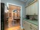 View from the kitchen, leading to an adjacent dining room with a table and chairs at 307 Golden Bear Dr. # 3, Pawleys Island, SC 29585