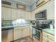 Modern kitchen with stainless steel appliances, neutral cabinets, and a stylish tile backsplash at 307 Golden Bear Dr. # 3, Pawleys Island, SC 29585
