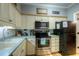The kitchen features modern stainless steel appliances and white cabinets with stylish hardware at 307 Golden Bear Dr. # 3, Pawleys Island, SC 29585