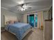 Relaxing main bedroom with a blue patterned bedspread, sliding glass doors to the outside, and neutral walls at 307 Golden Bear Dr. # 3, Pawleys Island, SC 29585