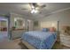Bright bedroom with blue patterned bedspread, white furniture, and a large mirror over the dresser to create more space at 307 Golden Bear Dr. # 3, Pawleys Island, SC 29585