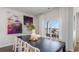 Bright dining area with a modern table, white chairs, stylish artwork, and sliding glass doors to an outdoor patio at 311 Glade Ct., Loris, SC 29569