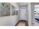 Inviting hallway with wood floors, light gray walls, and decorative wall art, leading to a bright entryway at 311 Glade Ct., Loris, SC 29569