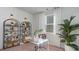 Stylish home office with modern clear desk, shelving, and natural light from the window at 311 Glade Ct., Loris, SC 29569