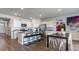 Open-concept kitchen with a large island, stainless steel appliances, white cabinets, and adjacent dining area at 311 Glade Ct., Loris, SC 29569