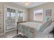 Cozy bedroom with a ceiling fan, natural light, and access to a balcony at 312 47Th Ave. N, North Myrtle Beach, SC 29582