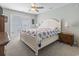Bright bedroom with a white bed frame, a ceiling fan, and sliding glass doors to an outdoor deck at 312 47Th Ave. N, North Myrtle Beach, SC 29582