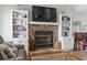 Close up of a cozy stone fireplace with built-in bookshelves and nautical decor accents at 312 47Th Ave. N, North Myrtle Beach, SC 29582