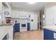 Functional kitchen featuring a suite of white appliances and blue lower cabinets at 312 47Th Ave. N, North Myrtle Beach, SC 29582