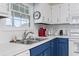 Bright kitchen featuring white and blue cabinets, stainless steel sink, and modern appliances at 312 47Th Ave. N, North Myrtle Beach, SC 29582