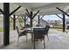 Outdoor dining area under elevated home, featuring a glass table and seating for waterfront enjoyment at 312 47Th Ave. N, North Myrtle Beach, SC 29582