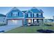 Charming two-story home with blue siding, stone accents, a two-car garage, and well-manicured lawn at 316 Glacier Way, Conway, SC 29526