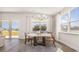 Bright dining room with stylish chandelier, large windows, and sliding glass doors with water view at 334 Glacier Way, Conway, SC 29526