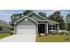 Charming single-story home with gray siding, attached garage, and manicured front lawn at 334 Glacier Way, Conway, SC 29526
