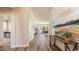 Hallway view featuring wood-look floors leading to a living room with neutral paint and modern decor at 334 Glacier Way, Conway, SC 29526