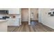 Bright kitchen featuring white cabinets, stainless steel appliances, and wood-look flooring at 334 Glacier Way, Conway, SC 29526