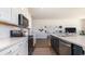 Well-appointed kitchen with quartz counters, white and navy cabinets, and stainless steel appliances at 334 Glacier Way, Conway, SC 29526
