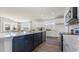 Open-concept kitchen featuring an island with seating, quartz countertops, and stainless steel appliances at 334 Glacier Way, Conway, SC 29526