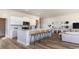Spacious open-concept floor plan with an eat-in kitchen island, bar stools, and living area at 334 Glacier Way, Conway, SC 29526