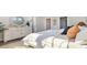Comfortable primary bedroom with neutral decor, stylish furniture, large windows for natural light, and walk-in closet access at 334 Glacier Way, Conway, SC 29526