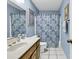 Cozy bathroom featuring blue walls, patterned shower curtain and white tiled floors at 405 N Hillside Dr. N # C3, North Myrtle Beach, SC 29582