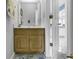 Well-lit bathroom with a wood vanity and a peek into the hallway at 405 N Hillside Dr. N # C3, North Myrtle Beach, SC 29582