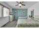 Comfortable bedroom with two beds, a ceiling fan, and bright windows at 405 N Hillside Dr. N # C3, North Myrtle Beach, SC 29582